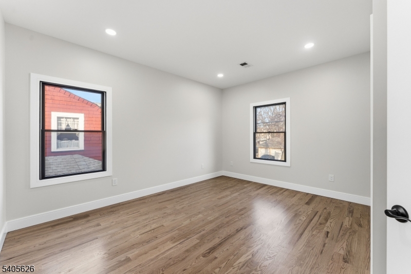 228 Locust Street Roselle, NJ 07203 - Photo 12 of 35 a view of an empty room with wooden floor and a window