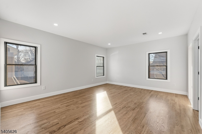 228 Locust Street Roselle, NJ 07203 - Photo 16 of 35 a view of an empty room with wooden floor and a window