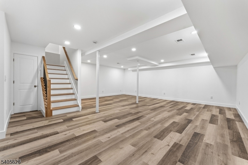 228 Locust Street Roselle, NJ 07203 - Photo 23 of 35 en empty room with stairs and wooden floor