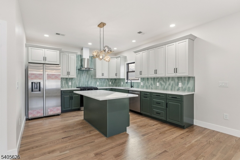 228 Locust Street Roselle, NJ 07203 - Photo 7 of 35 a kitchen with kitchen island granite countertop a sink cabinets and stainless steel appliances