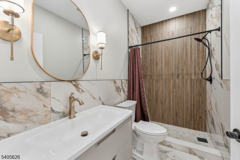 228 Locust Street Roselle, NJ 07203 - Photo 9 of 35 a bathroom with a sink a toilet and shower curtain
