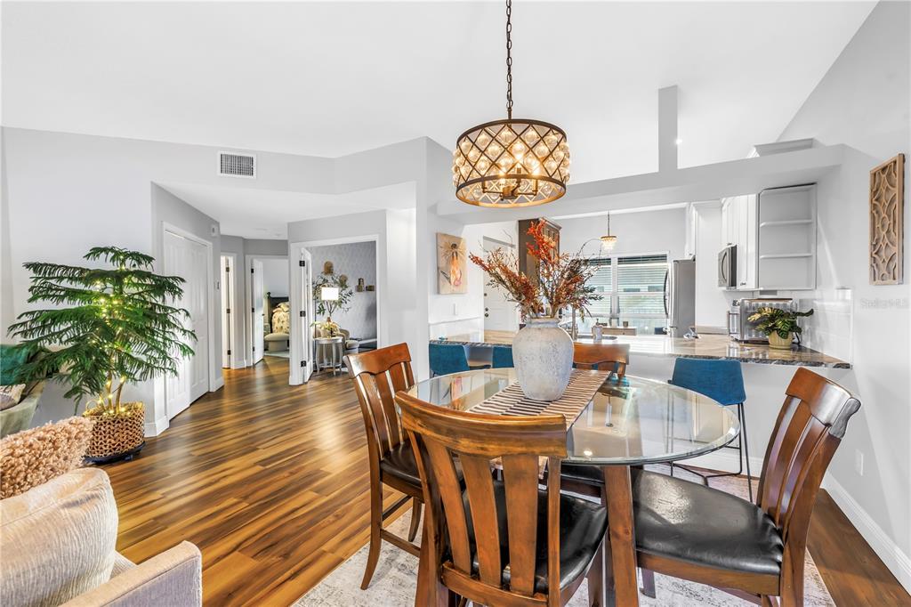 6311 99th Way North, Unit 11A St. Petersburg, FL 33708 - Photo 15 of 52 a view of a dining room and hall with furniture