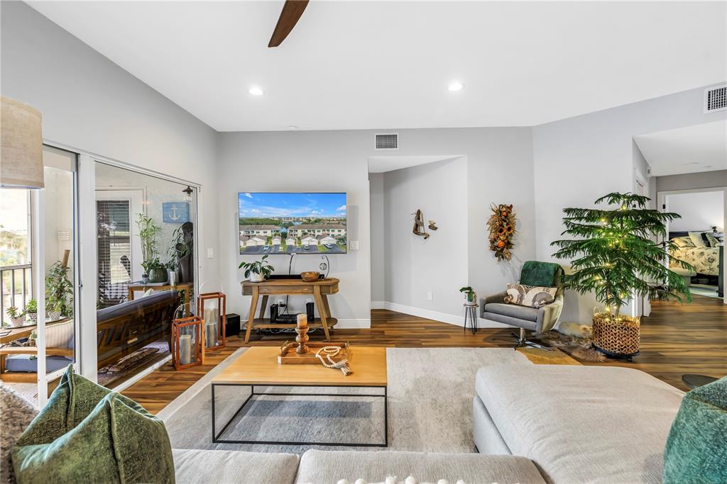 6311 99th Way North, Unit 11A St. Petersburg, FL 33708 - Photo 16 of 52 a living room with furniture and a table