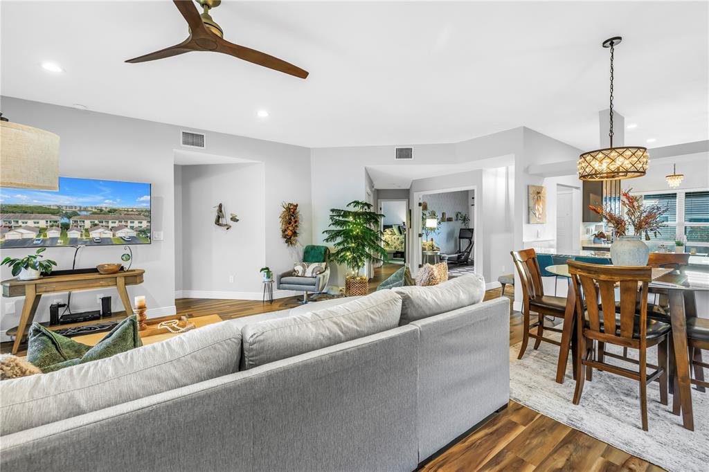 6311 99th Way North, Unit 11A St. Petersburg, FL 33708 - Photo 17 of 52 a living room with furniture dining table and a chandelier