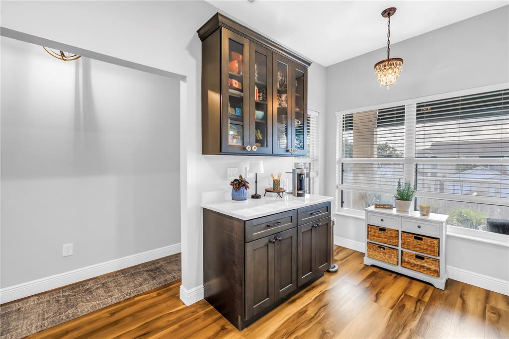 6311 99th Way North, Unit 11A St. Petersburg, FL 33708 - Photo 20 of 52 a kitchen with a stove a sink and wooden floor
