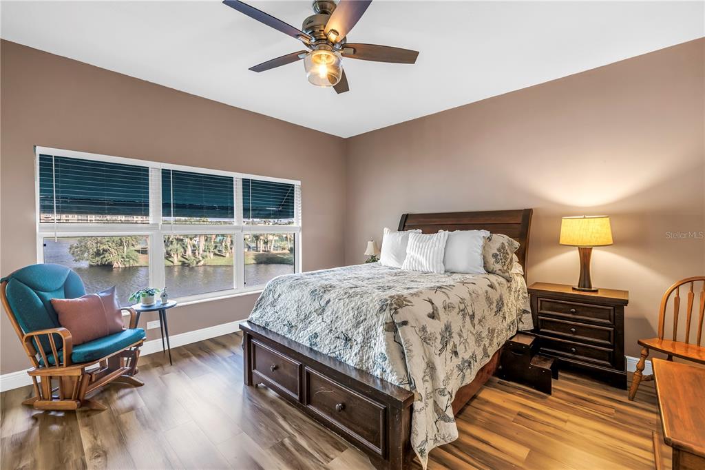 6311 99th Way North, Unit 11A St. Petersburg, FL 33708 - Photo 24 of 52 a bedroom with a bed and wooden floor