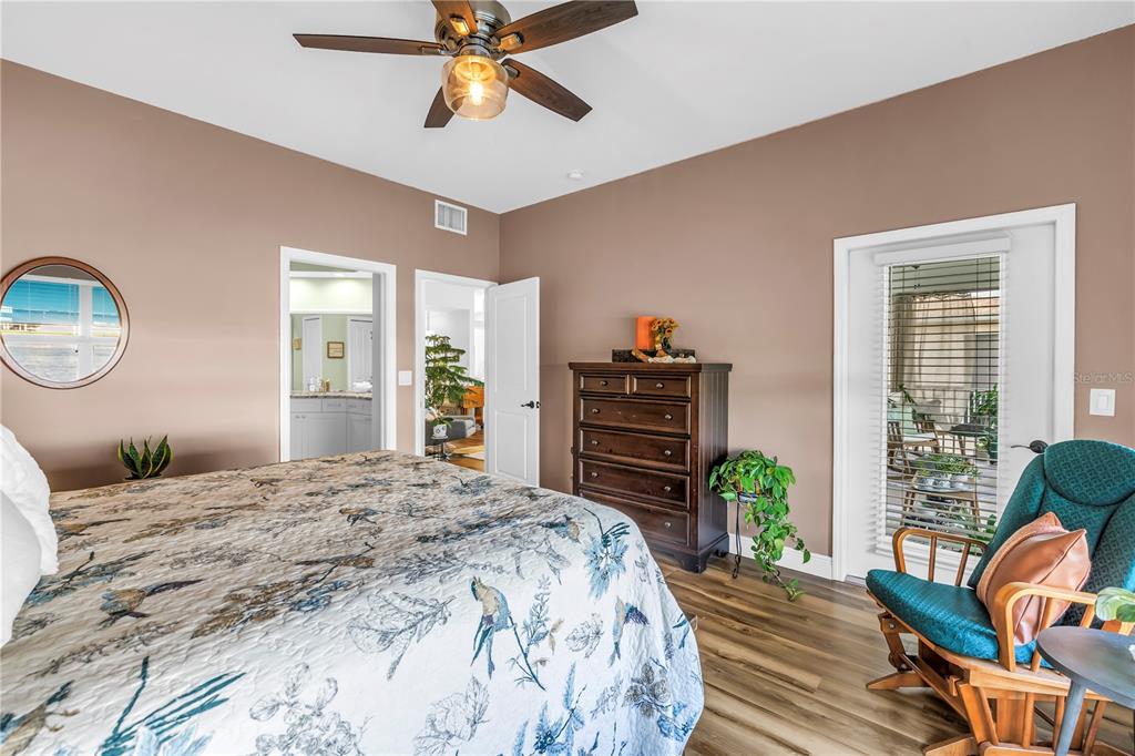 6311 99th Way North, Unit 11A St. Petersburg, FL 33708 - Photo 25 of 52 a bedroom with a bed and a chandelier