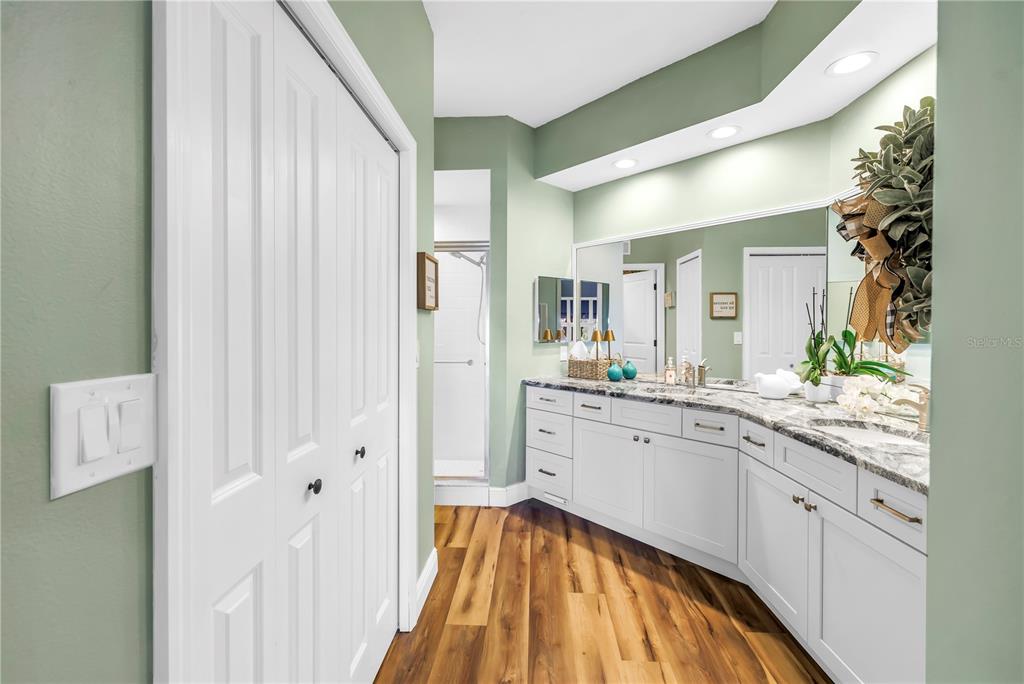 6311 99th Way North, Unit 11A St. Petersburg, FL 33708 - Photo 26 of 52 a spacious bathroom with a granite countertop sink and a mirror
