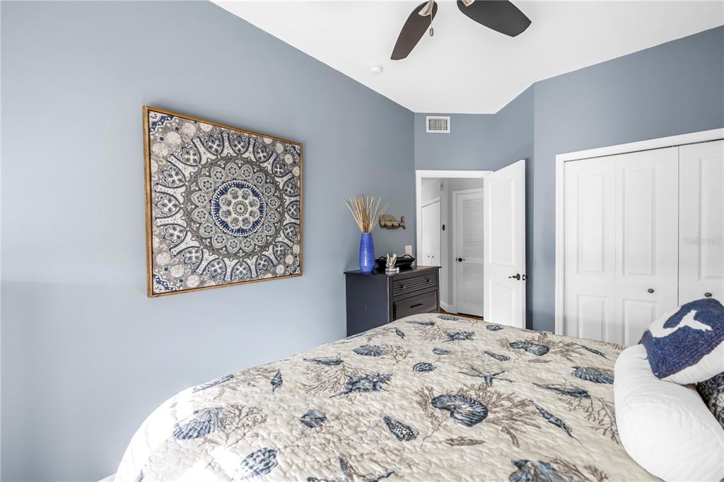 6311 99th Way North, Unit 11A St. Petersburg, FL 33708 - Photo 28 of 52 a bedroom with a bed and a chandelier