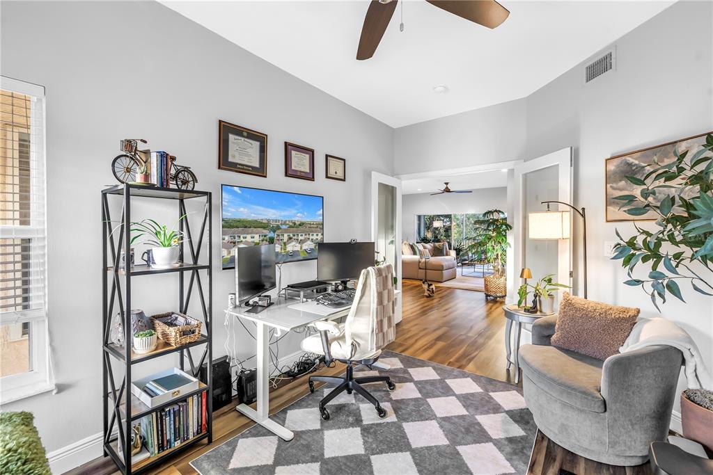 6311 99th Way North, Unit 11A St. Petersburg, FL 33708 - Photo 31 of 52 a living room with furniture and a floor to ceiling window