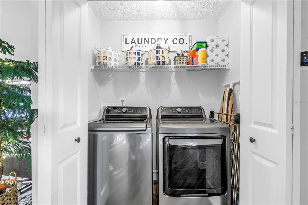 6311 99th Way North, Unit 11A St. Petersburg, FL 33708 - Photo 33 of 52 a utility room with wooden floor washer and dryer