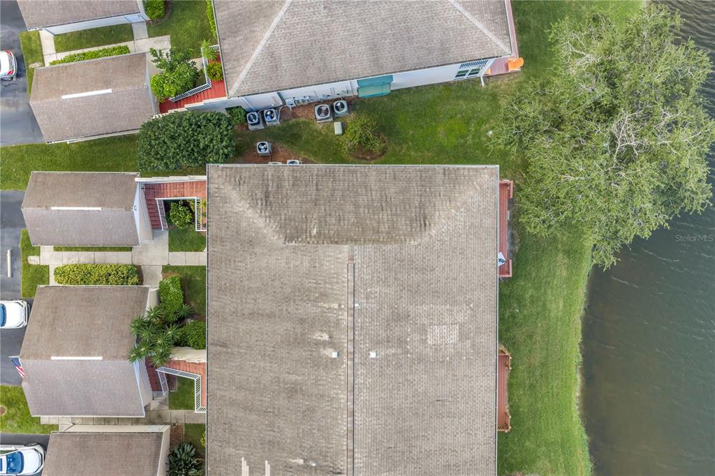 6311 99th Way North, Unit 11A St. Petersburg, FL 33708 - Photo 43 of 52 an aerial view of a house with a yard