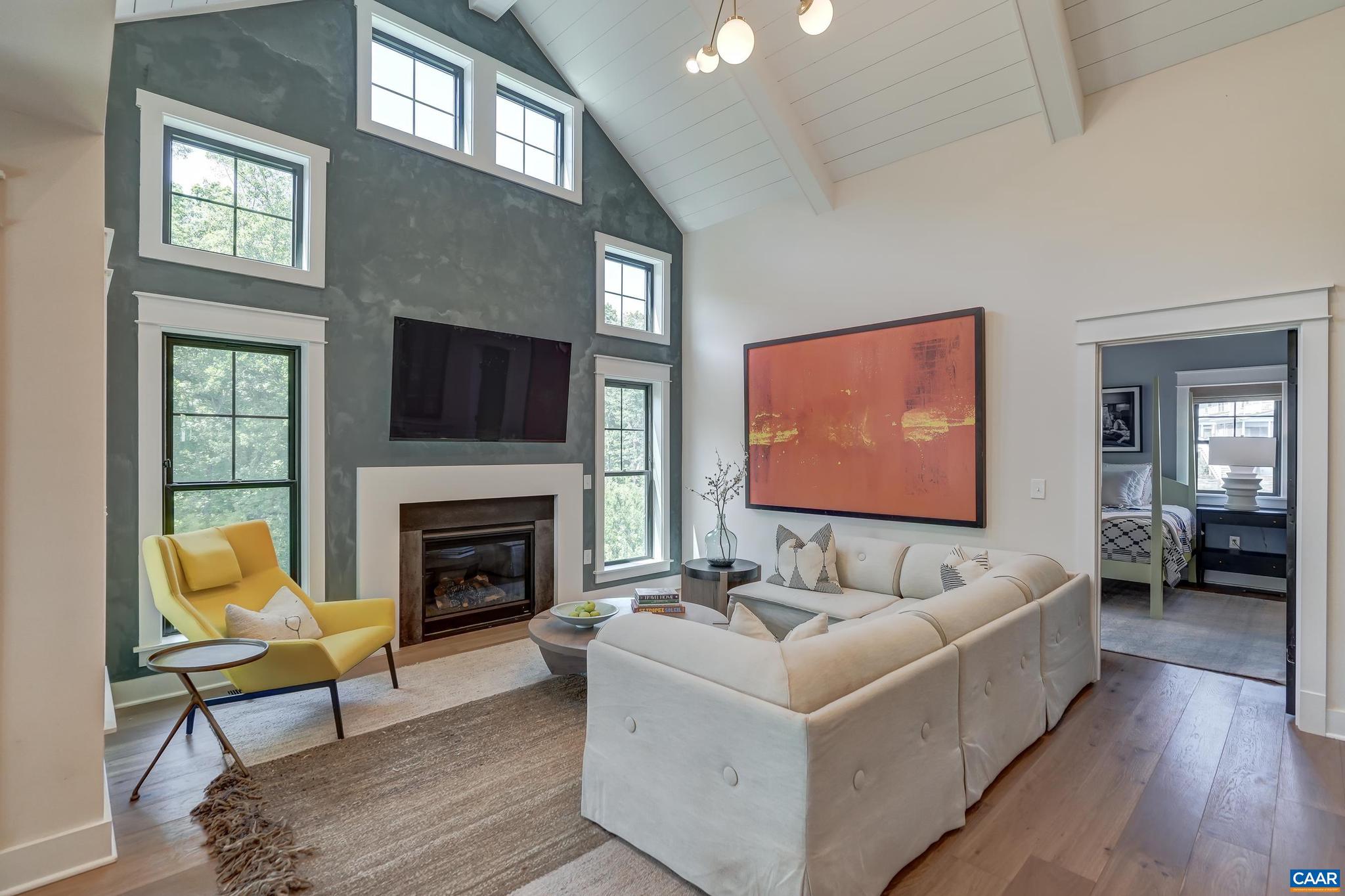 3327 Rowcross Street Crozet, VA 22932 - Photo 19 of 63 a living room with furniture a fireplace and a flat screen tv