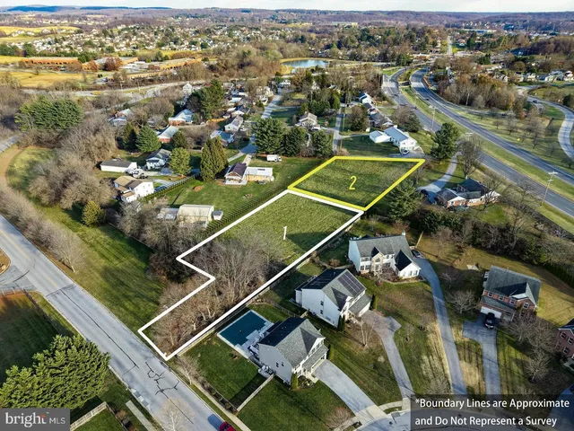 an aerial view of a pool yard and outdoor seating