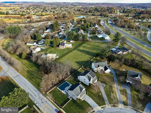 an aerial view of residential houses with outdoor space
