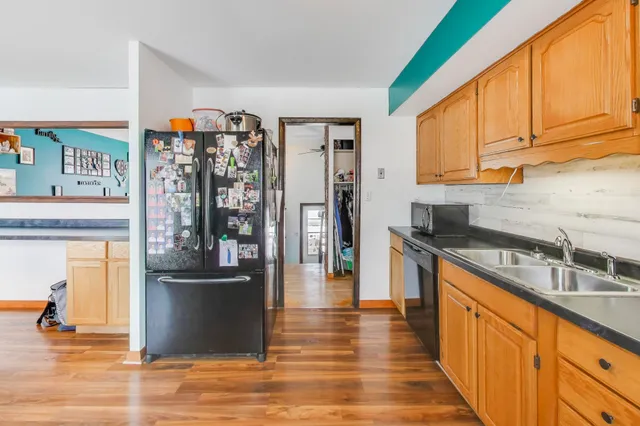 a kitchen with stainless steel appliances granite countertop a refrigerator and a sink