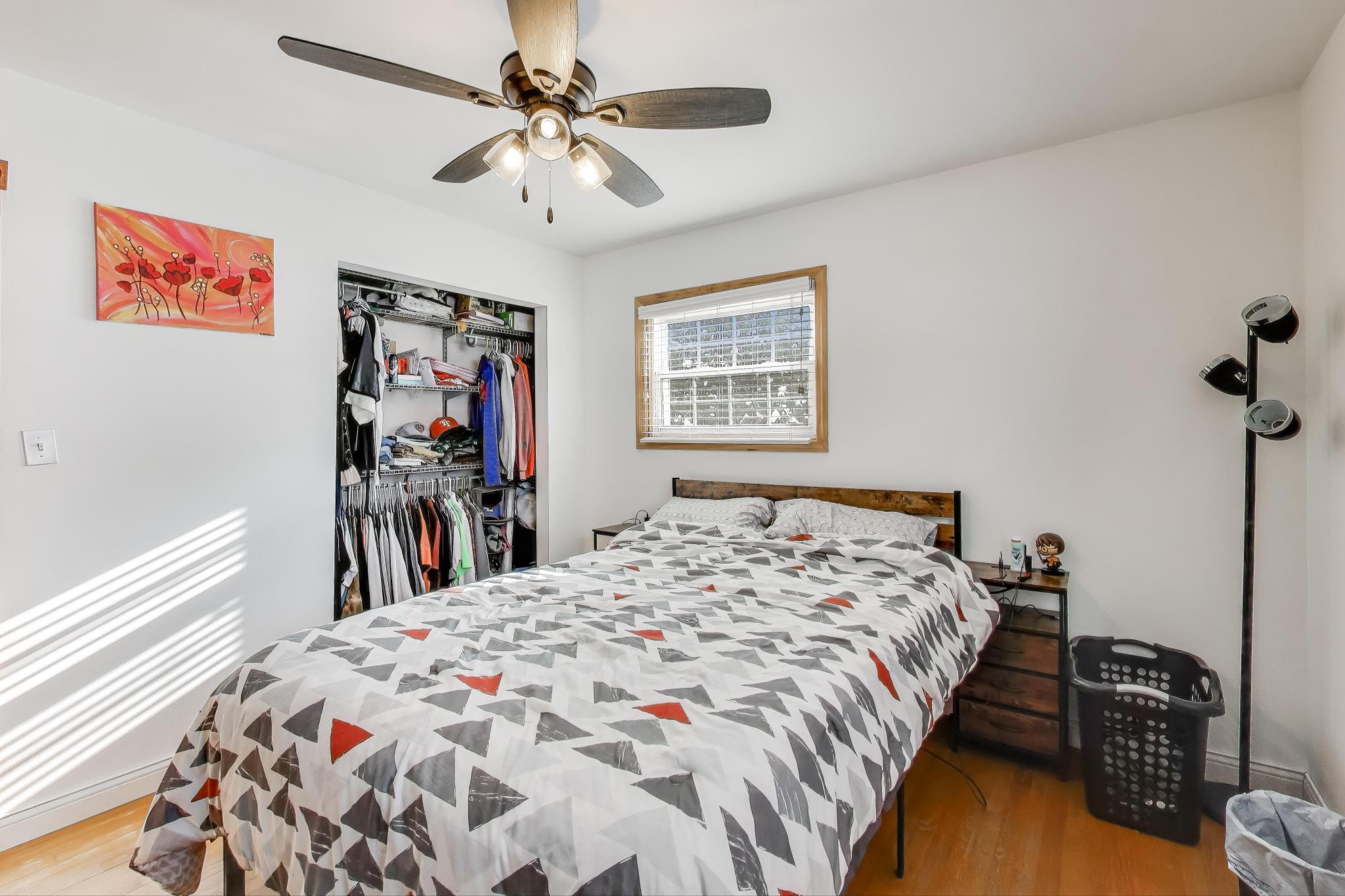 1044 North Rensselaer Street Griffith, IN 46319 - Photo 13 of 32 a bed room with a bed and a chandelier