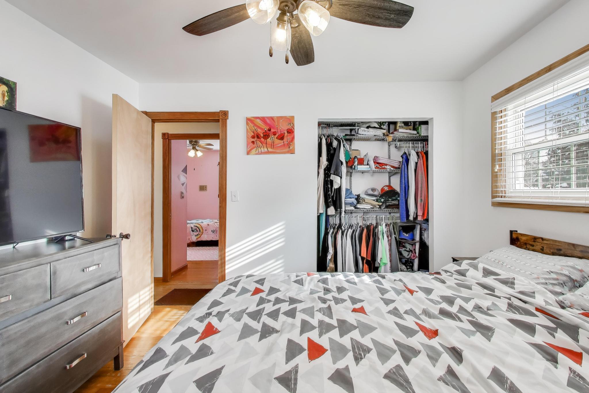 1044 North Rensselaer Street Griffith, IN 46319 - Photo 14 of 32 a bedroom with a bed and a flat tv screen on dresser