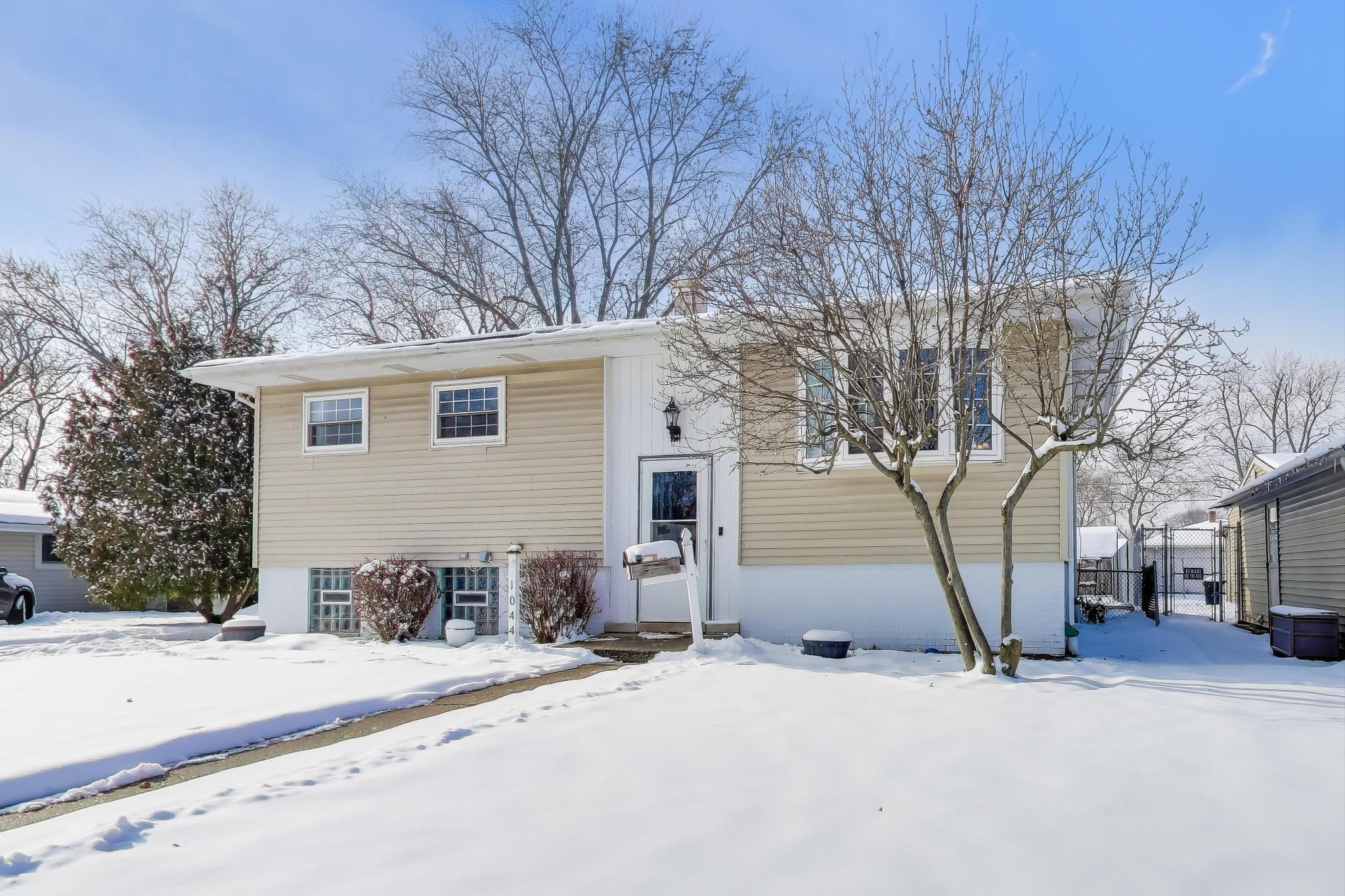 1044 North Rensselaer Street Griffith, IN 46319 - Photo 2 of 32 a house with a tree in front of it