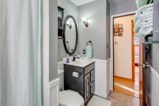 a bathroom with a toilet sink and mirror