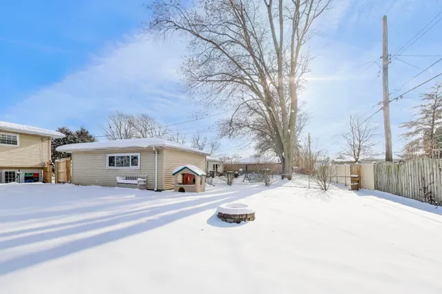 a view of a house with snow on the road