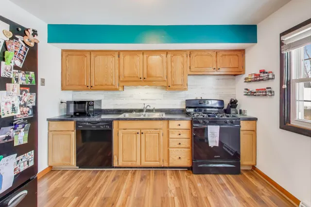 a kitchen with stainless steel appliances granite countertop a stove a sink and a refrigerator