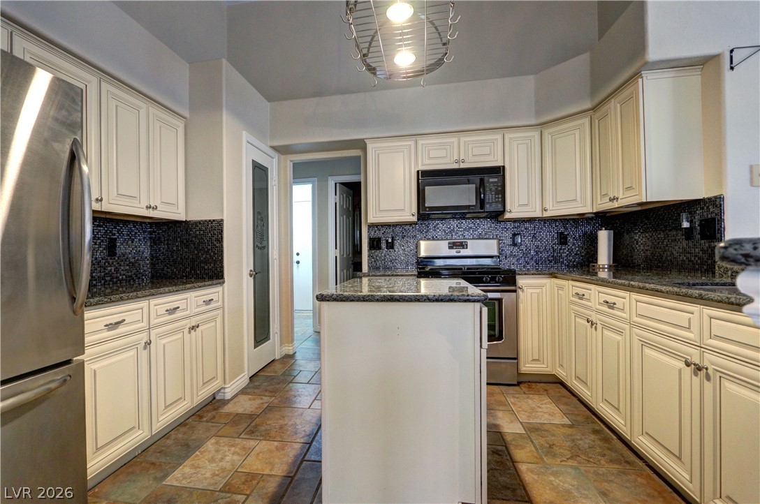2108 Crestpoint Way Las Vegas, NV 89134 - Photo 9 of 27 Culinary delights await in this inviting kitchen, featuring a central island and contemporary appliances.
