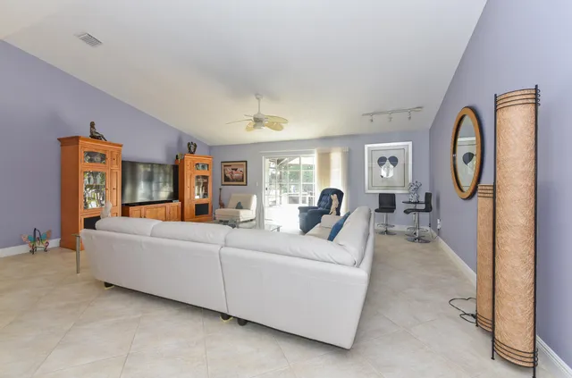 a living room with furniture and a clock