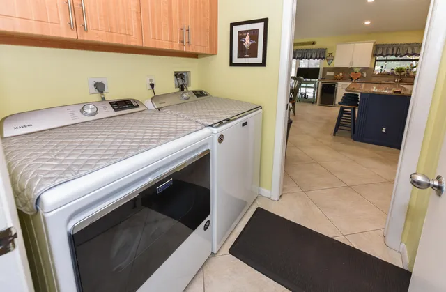 a kitchen with stainless steel appliances a stove microwave and refrigerator