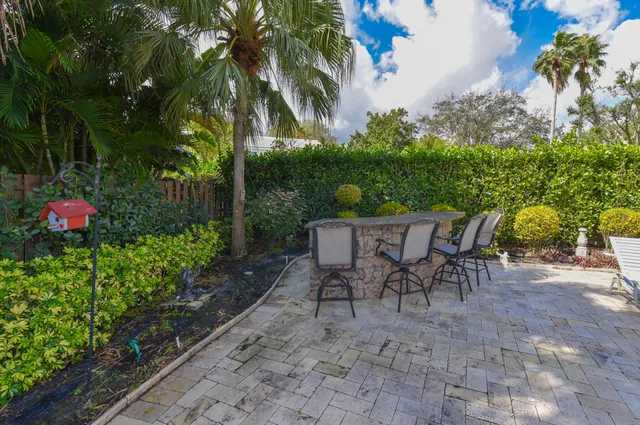 a view of a tables and chairs in a backyard