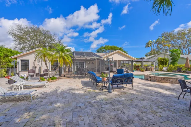 a view of a house with backyard and sitting area