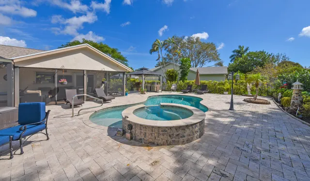 a view of a house with backyard and sitting area