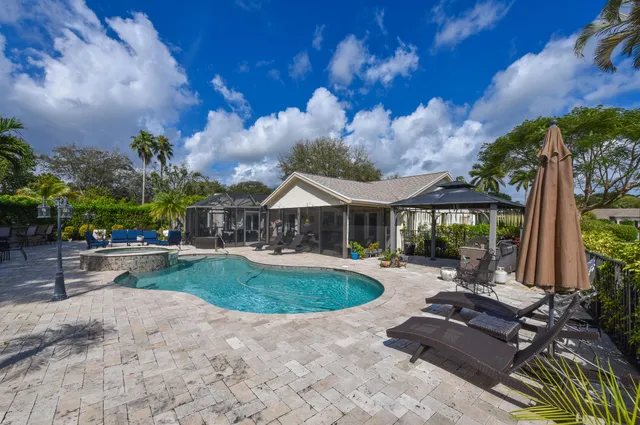 a view of a house with swimming pool and sitting area