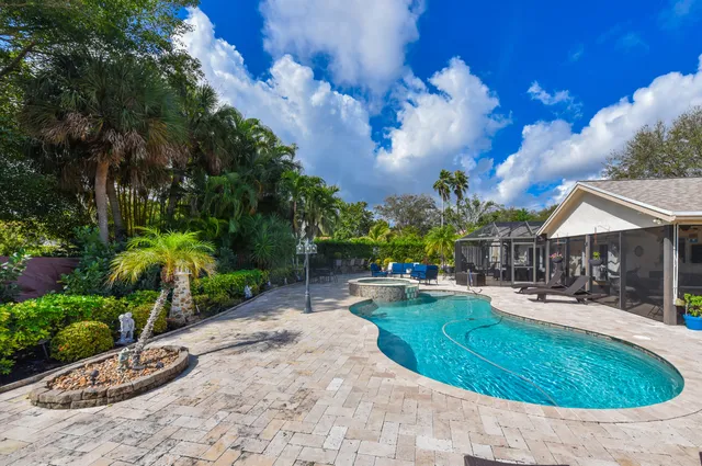 a swimming pool with outdoor seating and yard