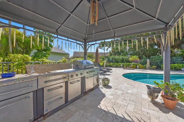 a open kitchen with stainless steel appliances granite countertop a sink and a table