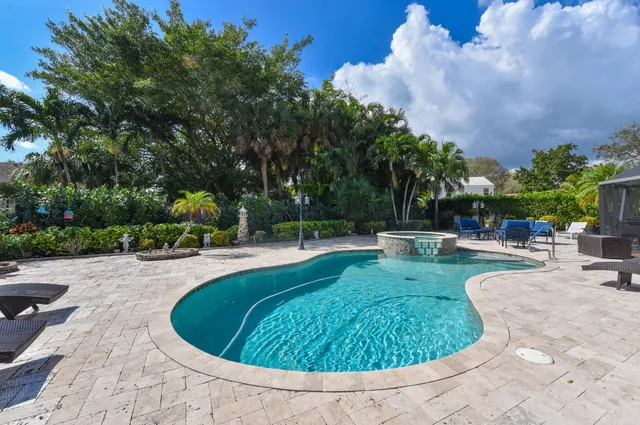 a view of a swimming pool with sitting area