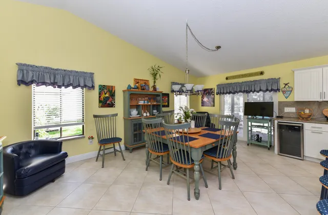 a view of a dining room with furniture and a kitchen