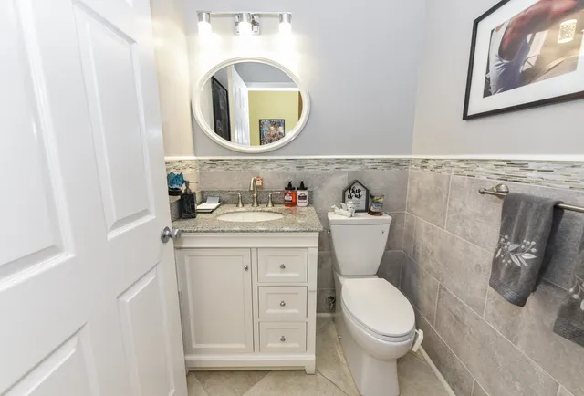 a bathroom with a toilet a sink and mirror