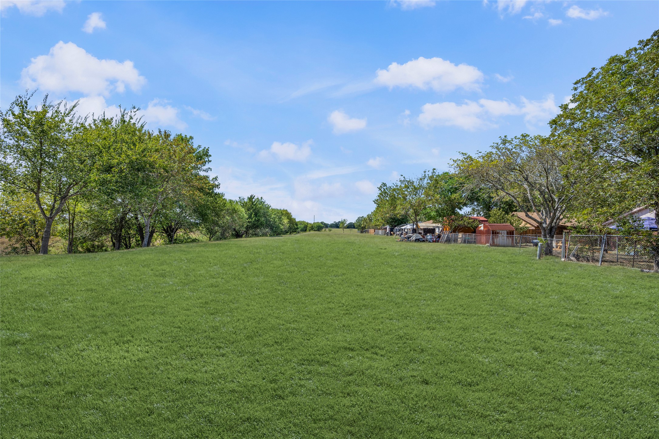 a view of field with trees in the background
