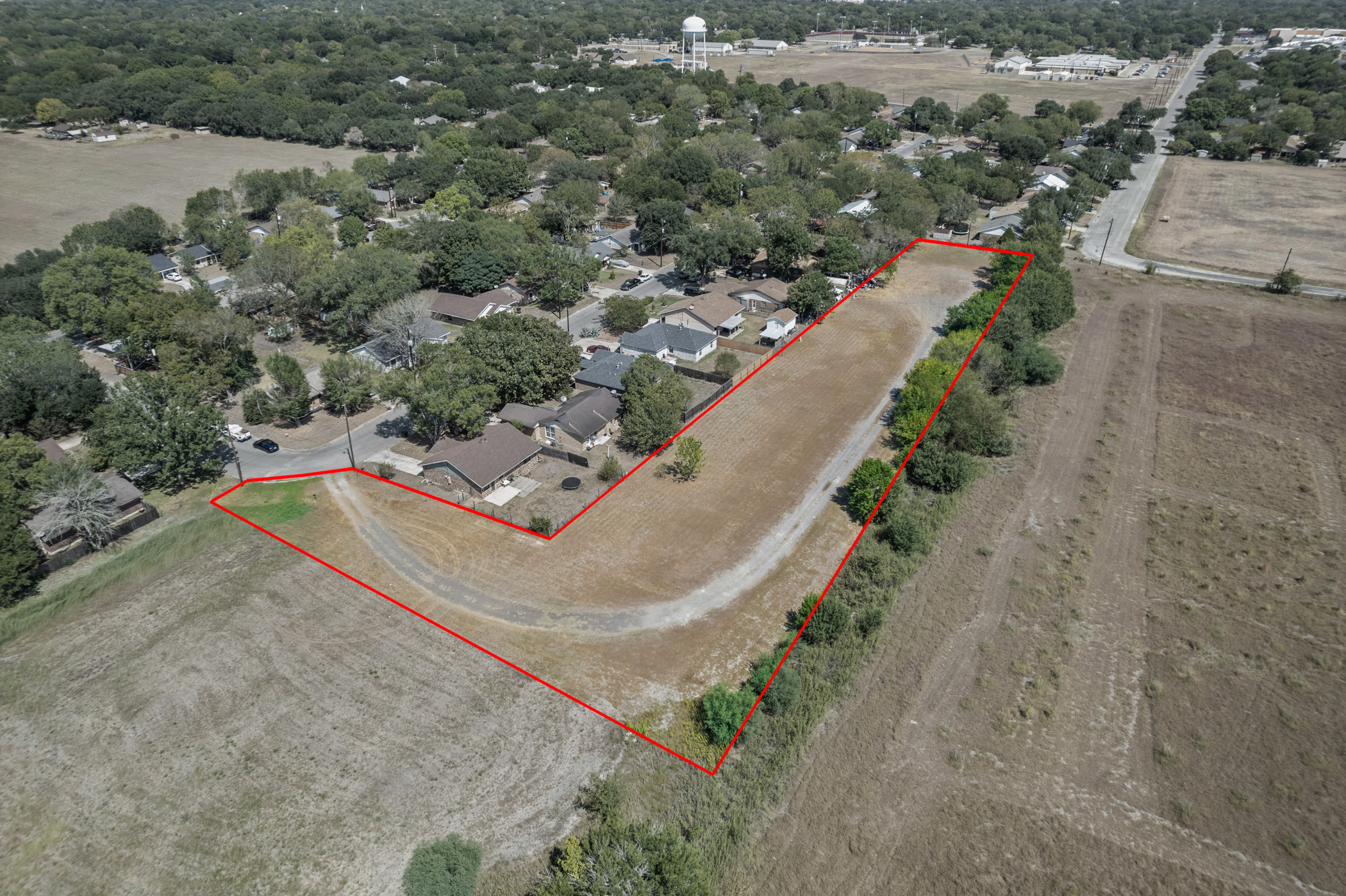 1508 Pendergrass Street Lockhart, TX 78644 - Photo 13 of 13 an aerial view of a house with a yard and lake