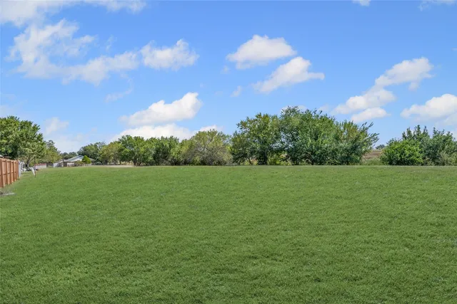 a view of field with trees in the background