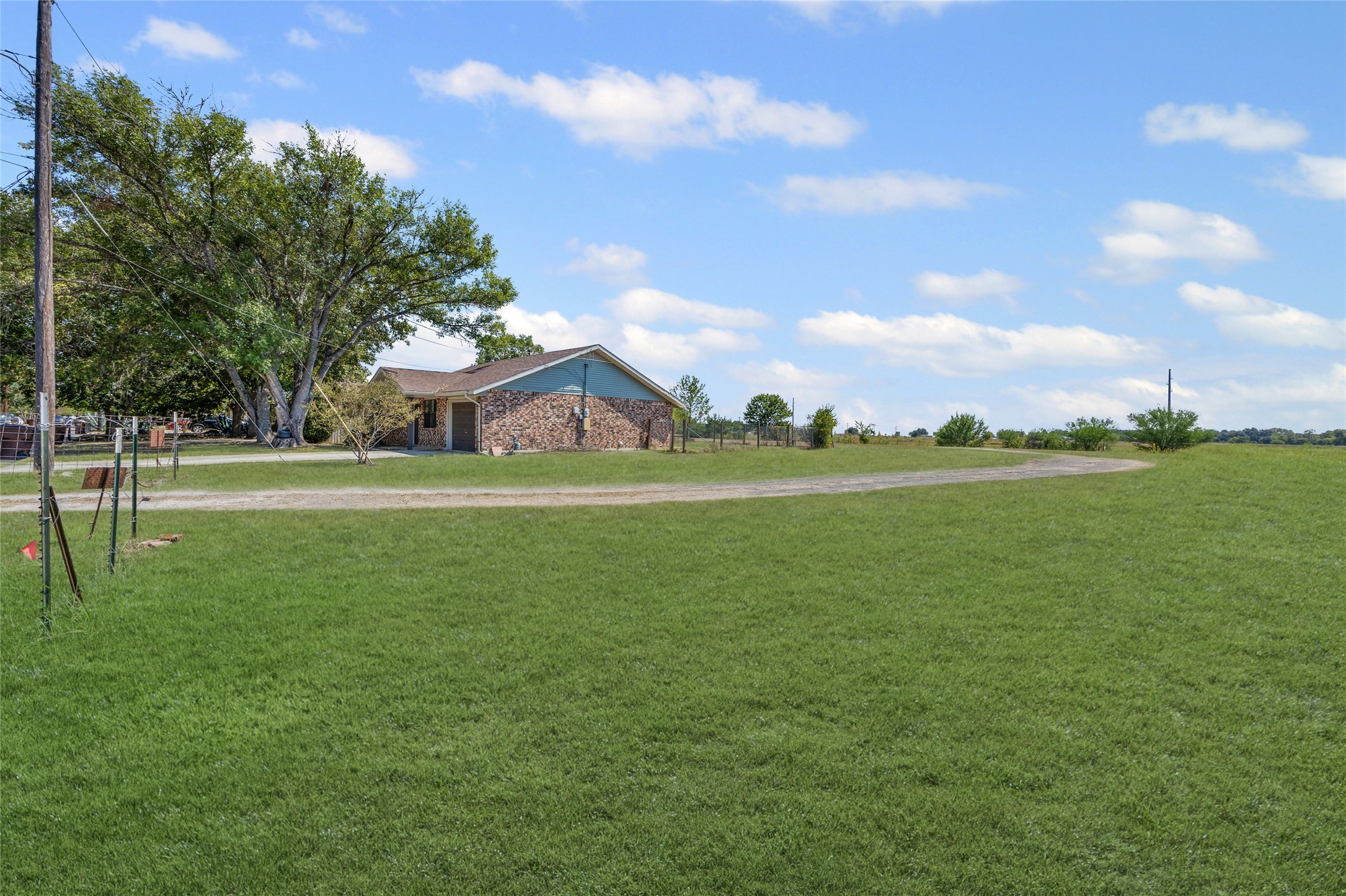 1508 Pendergrass Street Lockhart, TX 78644 - Photo 8 of 13 a view of a green field with wooden fence