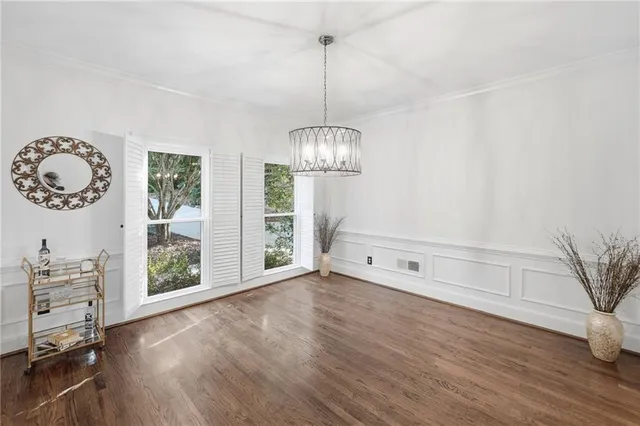 a view of a room with window wooden floor and front door
