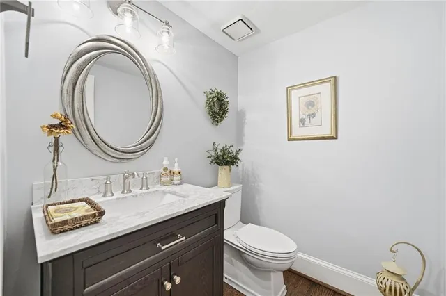 a bathroom with a toilet a sink and mirror