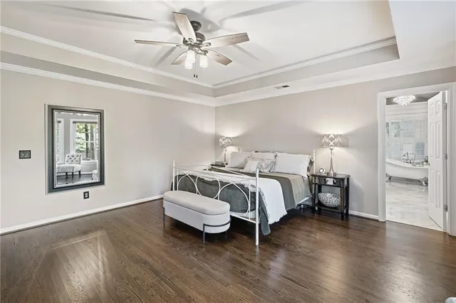 a spacious bedroom with a bed and a chandelier