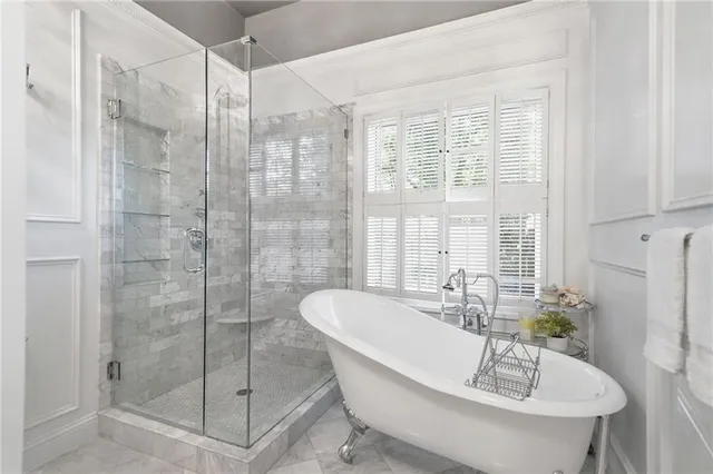 a bath tub sitting next to a shower