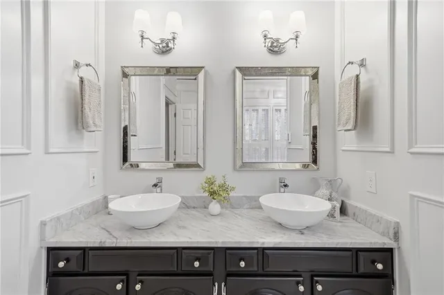 a bathroom with double sink and a mirror