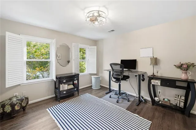 a livingroom with workspace and a window