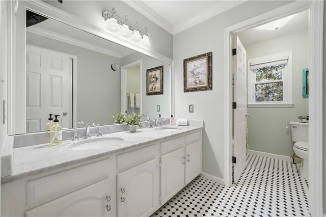 a bathroom with a sink a toilet and a mirror