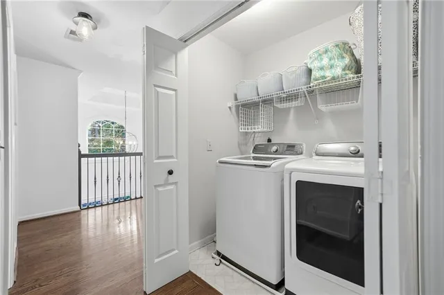a kitchen with white cabinets and wooden floor